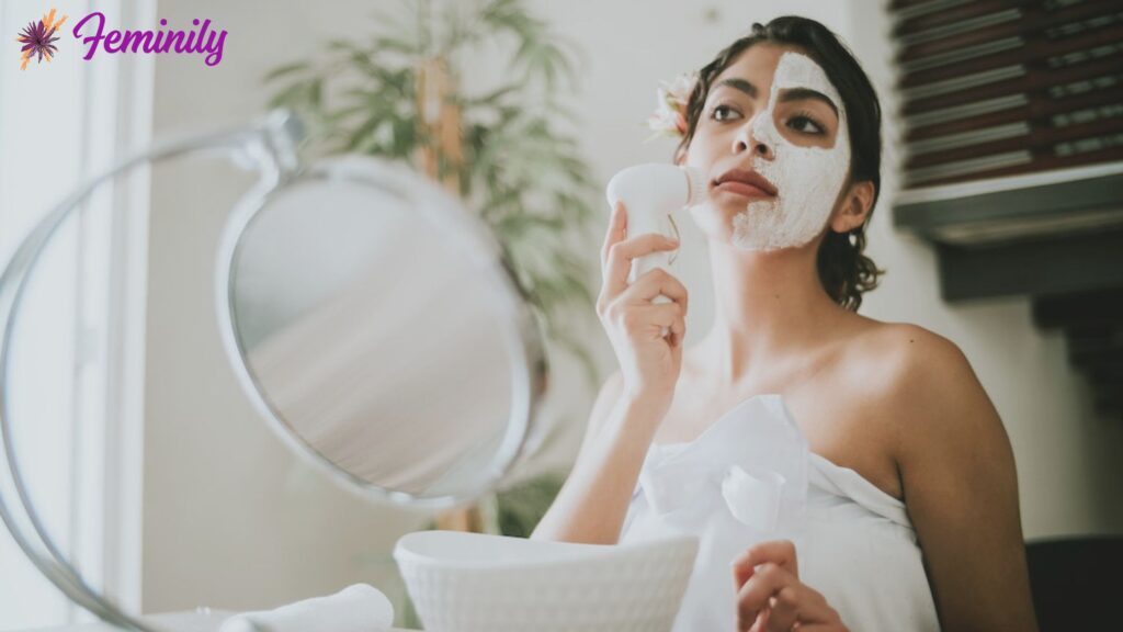 Woman washing her face using facial cleansing brush